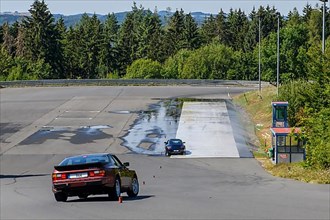 Historic sports car Porsche 944 Turbo Oldtimer Classic Car drives retains control on slalom course during driving safety training