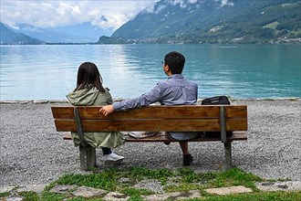 Asian tourist couple on a bench Lake Brienz