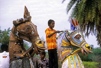 Village boys playing on the terracotta horses during Sivarathri festival in a village in Tamil Nadu