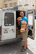 Moroccan baker with bread on his cart