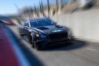 Dynamic photo with zoom effect of Bentley GT3 sports car racing car exiting pit lane