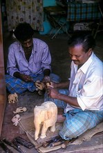 A craftsman with his sandalwood elephant