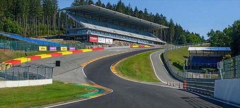 Panoramic photo of view from racing car perspective of racing driver while driving into dangerous curve Eau Rouge on 40 metres high driveway Raidillon of race track Circuit de Spa Francorchamps