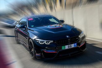 Dynamic photo with zoom effect of sports car race car BMW M4 leaving pit lane