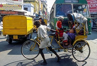 A cycle rickshaw crossing the road in Chennai