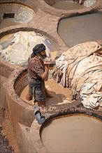 Workers dyeing leather