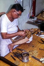 An artisan making wax mould for a bronze sculpture in Swamimalai