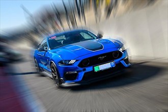 Dynamic photo with zoom effect of sports car race car Ford Mustang leaving pit lane