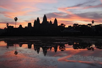 Khmer temple silhouetted at sunrise