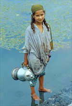 Kashmiri girl standing in a watercraft