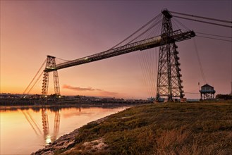 View of the transporter bridge over the river at dusk