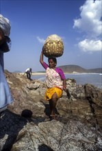 A woman carrying luggage on head in Gangavaram