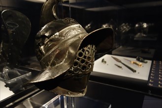 Thracian gladiator helmet and weapons on display at the Gallo-Romeins Museum