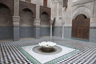 Madrasah courtyard with fountain in city