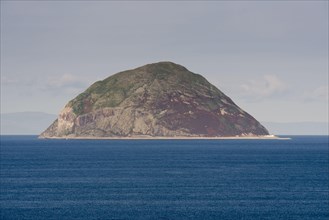 View of volcanic plug island and sea