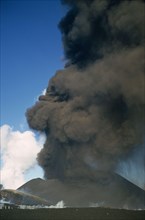 Rising column of smoke and ash from erupting volcano