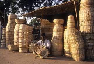 A man weaving bamboo strips baskets at Lawley Road in Coimbatore