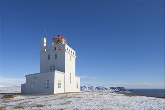 Dyrholaey lighthouse near Vik i Myrdal on the central south coast of Iceland in the snow in winter