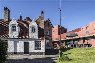 Medieval poorhouse and bus station in front of the concert hall in Bruges