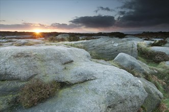 View from Gritstone rocks onto moorland habitat at sunset