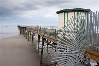 View of beach and enclosed iron pier