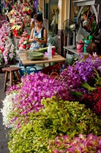 Thai woman selling flowers at Pat Khlong Talat market