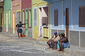 Creole woman talking on the doorstep in the street in the village of Sal Rei on Boa Vista Island