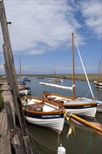 Moored sailboats in coastal creek