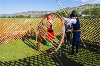 Kazakh men building a yurt