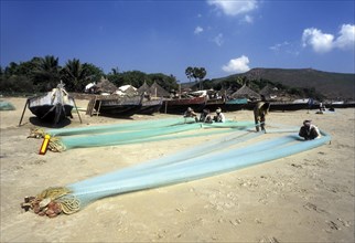 Fishermen repairing their fishing nets in Gangavaram