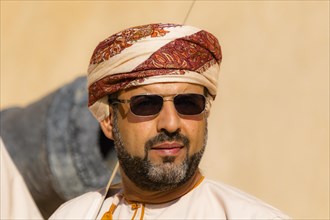 Man performing traditional songs during the Friday Goat Market in Nizwa