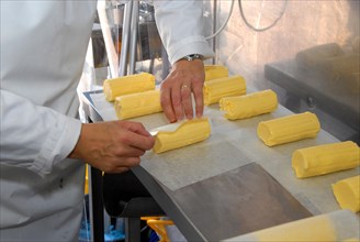 Worker wrapping organic butter made from unpasteurised milk