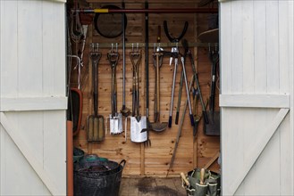 Garden tools in garden arbour