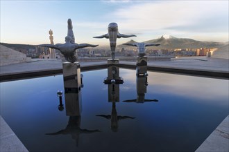 Modern sports sculptures reflected in the water