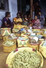 Beedi workers waiting for deliver their rolled beedis to the company
