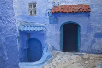 Blue doors and houses in alley of city