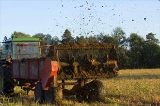 John Deere tractor pulling manure spreader