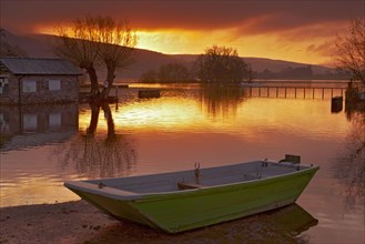Boat on the lake at sunrise at high water level