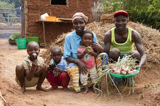 Family showing vegetables grown in the garden