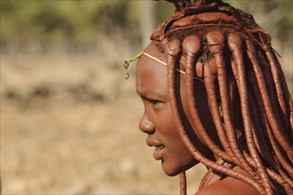 Himba girl with traditional ochre braid hairstyle