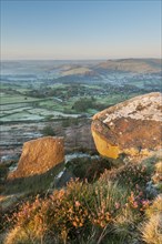 View of cliffs and moorland across the valley at sunrise in frost
