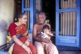 A Palghat Brahmin family sitting in front of their house in Kalpathy near Palakkad or Palghat
