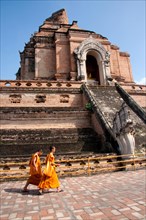 Two monks walking in front of Wat Chedi Luang