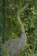 Ornamental wire mesh heron in garden