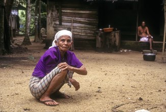 An old woman sitting on the floor