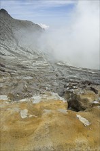 Slopes of a volcanic crater with rising steam
