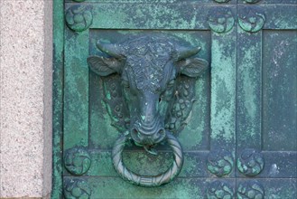 Bull's head detail of a bronze cathedral door in the historic town