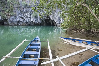 Tourist boats in front of the cave entrance of the Subterranean River