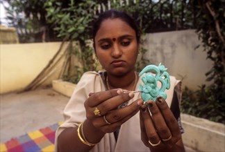 A girl carving images on soap in Rajapalayam