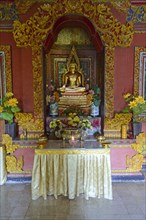 Buddha statue on altar in prayer room of the Buddhist monastery Brahma Vihara